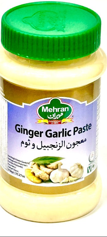 Jar of Ginger Garlic Paste with green lid on a white background